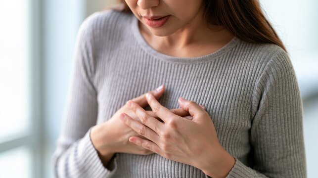 hand hold chest with heart attack symptoms, have chest pain caused by heart disease, leak, dilatation, enlarged coronary heart, press on the chest with a painful expression