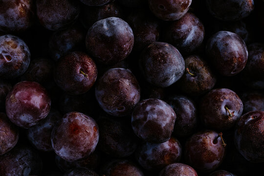 Close-up of ripe black plum fruit background texture