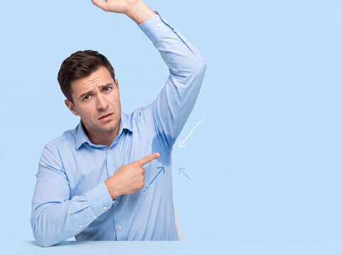 Man points to underarm while raising his arm