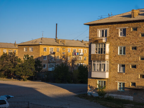 Soviet-era Apartment Buildings Under Clear Blue Sky