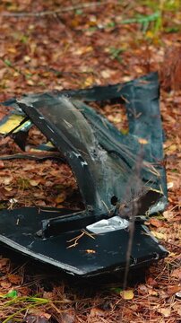 A destroyed military drone lies in a forest, highlighting environmental damage caused by the Russia-Ukraine war in Europe, including debris pollution and threats to the natural ecosystem.