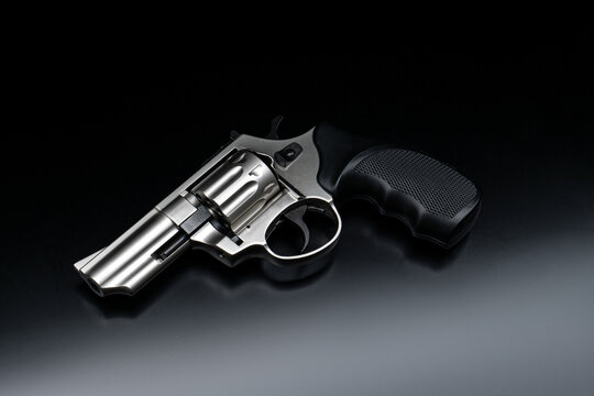 Silver revolver firearm on dark background