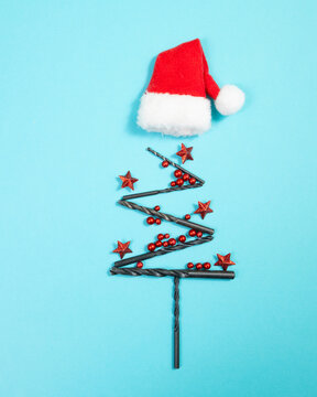 Christmas tree made from drill, red stars, baubles and Santa Claus hat, holiday greeting card, banner or background for handyman, craftsman or repairman, advent winter season