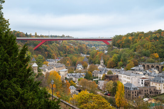 Red bridge crossing the Alzette river valley in Luxembourg city, historical landmark of Pfaffenthal, Ville Haute view point, autumn season in Luxembourg