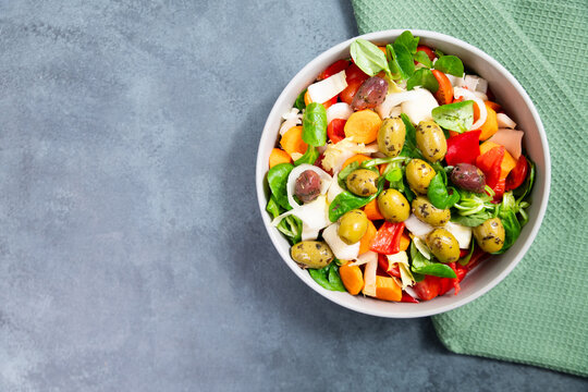 Salad bowl with lettuce, chicory, olives, cucumber, spinach, tomatoes and herbs, healthy mediterranean food, homemade meal, lifestyle and nutrition diet