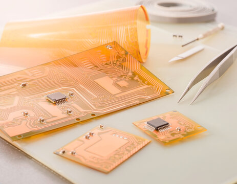 Flexible Printed Circuit Boards with Microchips on Electronics Engineering Workbench