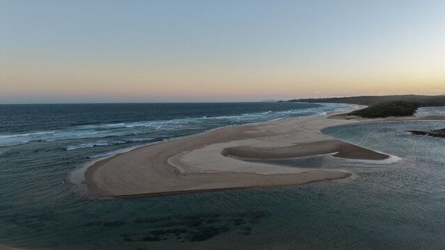 A curving sand spit at the mouth of the Nambucca River at dusk, NSW, Australia
