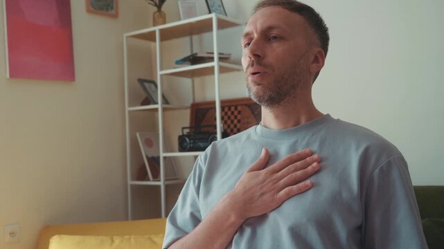 Man Practices Mindful Breathwork and Slow Exhalation for Stress Relief, Calm and Relaxation at Home