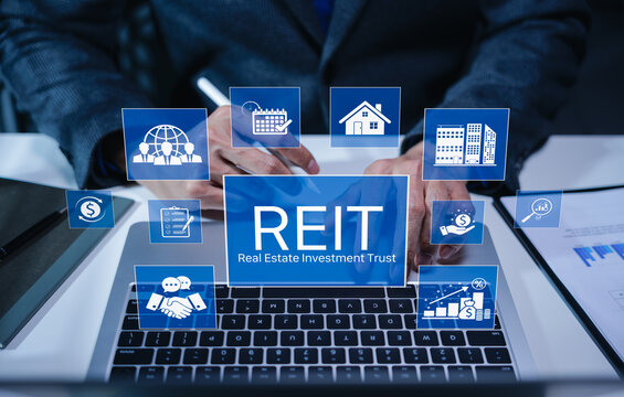 REIT, Real Estate Investment Trust Financial Concept. Businessman using laptop with REIT investment icons. property, finance charts, growth, mutual fund, investor, return, and income strategy.