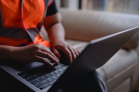 Foreman or engineer working with tablet AI artificial intelligence interface over laptop keyboard, programmer using machine learning automation technology Sustainable development and green business