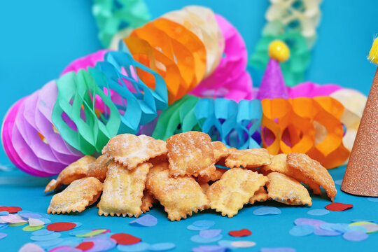 Rhenish pastries called 'Mutzen" pastries or ''Muzenbl&auml;tter' with powdered sugar on festive background. Traditional German carnival and Fasching fried pastry