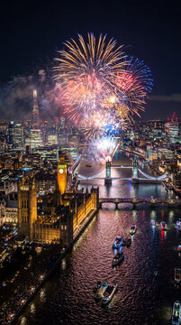 New Year's Eve fireworks in central London, Big Ben and London Eye glowing against the night sky, tourism, holiday festivities and cityscape
