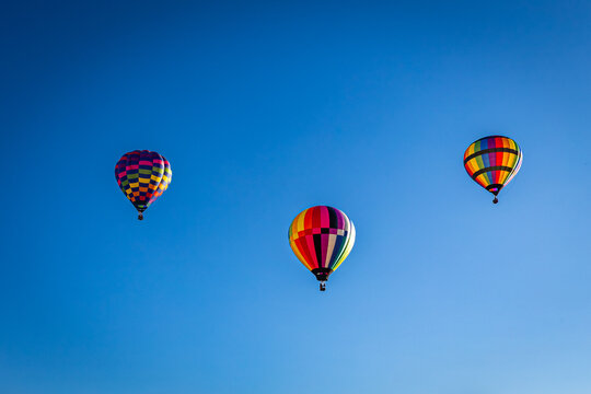 Three Hot Air Balloons in a Clear Blue Sky