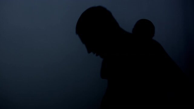 Fighters silhouettes punching dark background. Shirtless men fist fight combat.