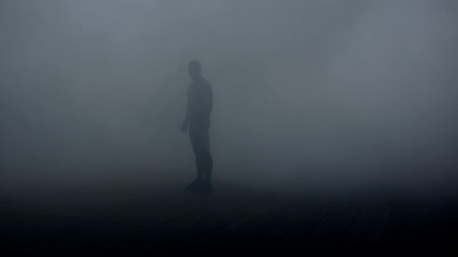 Silhouette man standing thick fog. Mysterious athletic figure dark smoke alone.