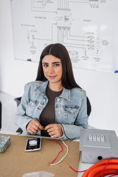 latina young woman student in an electricity class or electrical circuits at university in Mexico Latin America