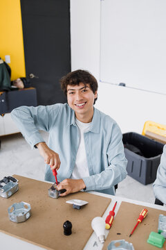 latin young man student in an electricity class or electrical circuits at university in Mexico Latin America