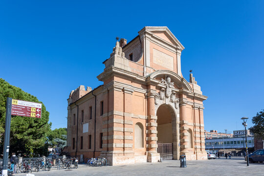 Bologna, Italy - October 14, 2026: Porta Galliera historic brick city gate with bicycles and signpost under blue sky in Bologna, Italy