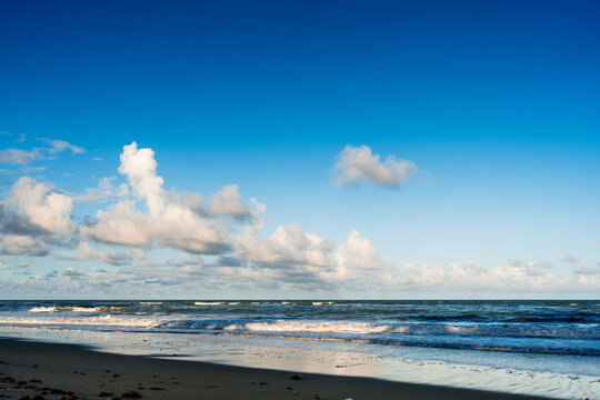 clouds in blue sky over beach and ocean