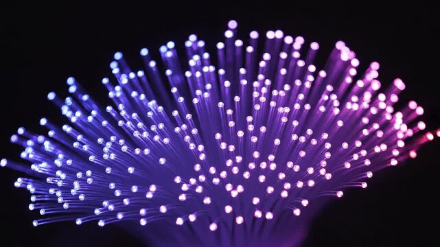 A composite of colorful fiber optic bundles glowing brightly. Abstract background representing data transfer, internet speed and network technology