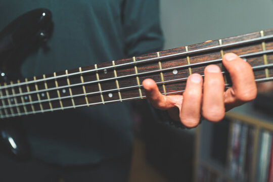 Bass Guitar Neck with a Hand Fretting a Chord Position