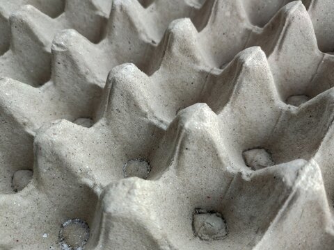 Empty cardboard egg crate pattern background, representing sustainable packaging, soundproof insulation material, and environmental recycling concepts.