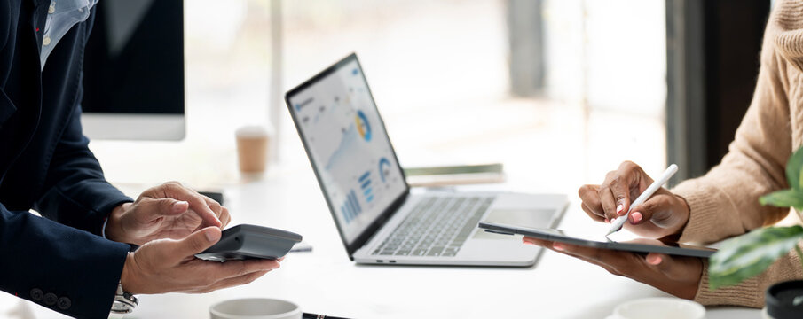 Panoramic View of Business Team Working and Analyzing Data on Digital Devices in Office