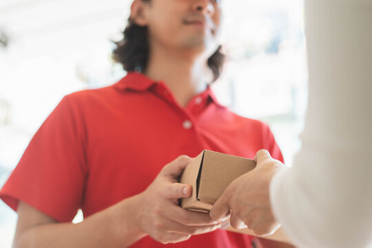 Delivery Man sending package to receiver on doorway.