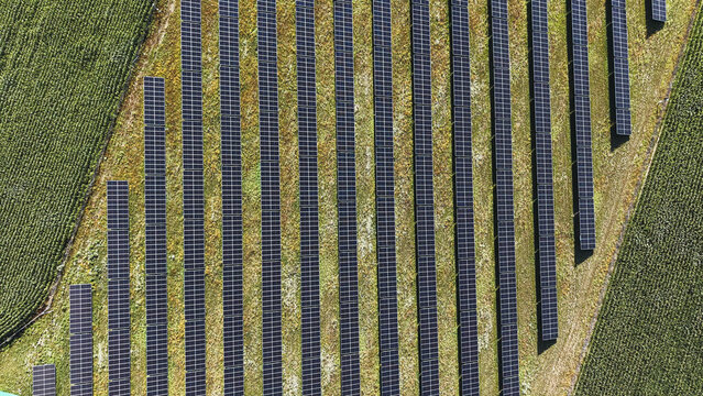 Drone view of solar panels installed in rural field