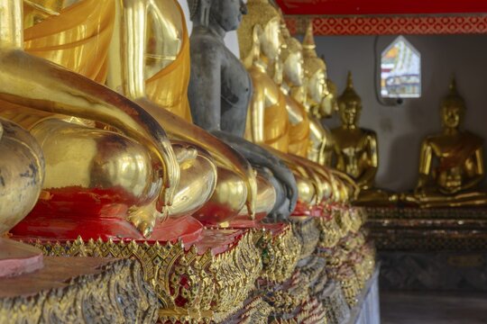 Gilded Buddha statues (Bhumispara-mudra: Gautama Buddha at the moment of enlightenment), Wat Pho, Bangkok, Thailand