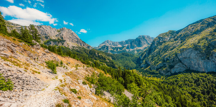 Alpine hiking trail from Prijevor in Bosnia to Trnovacko Lake in Montenegro, dramatic Dinaric Alps in Sutjeska park landscapes and crystal clear turquoise water.
