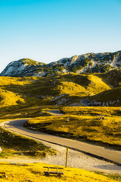 Grand panoramic view from Prutas peak at sunset, overlooking the dramatic limestone ridges and deep valleys of Durmitor National Park, Montenegro.