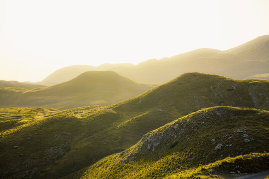 Grand panoramic view from Prutas peak at sunset, overlooking the dramatic limestone ridges and deep valleys of Durmitor National Park, Montenegro.