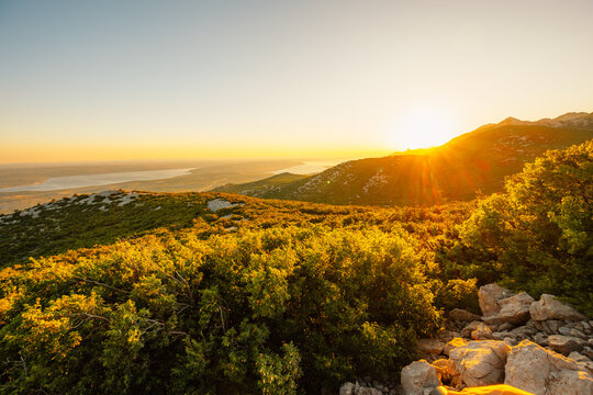 Majstorska road road at mountain Velebit in summer time in Croatia near croatia sea. Rocky peak of Tulove Grede at sunset
