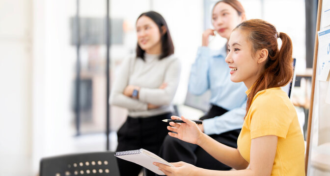 Asian Business Team Holding Meeting and Collaborating in Modern Office