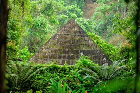 Ancient Stone Pyramid Structure Amid Dense Green Jungle Vegetation