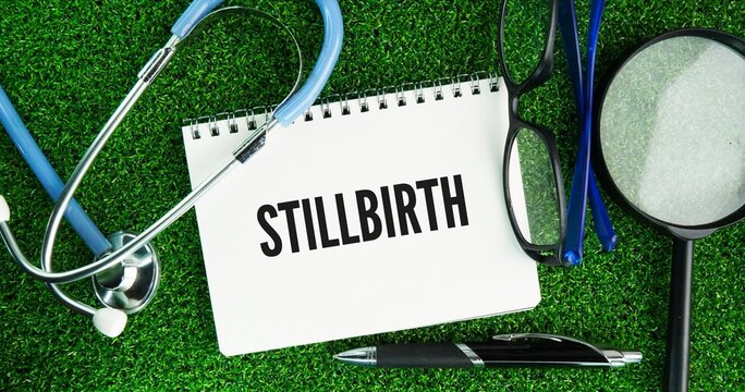 Stethoscope, glasses and paper with the words stillbirth is the loss of a baby born without signs of life at or after 20 to 28 weeks of pregnancy, depending on regional guidelines.