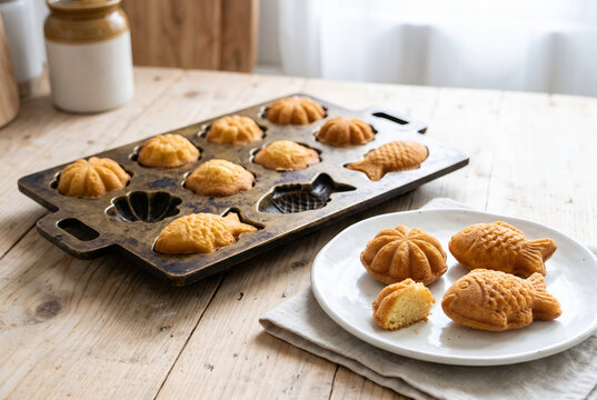 Golden sponge cakes in a traditional brass mould