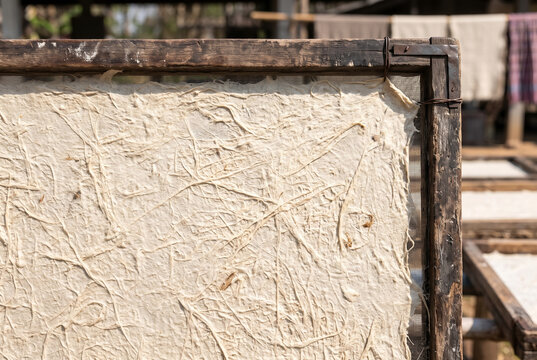Close-up of handmade mulberry paper drying on a wooden frame