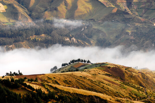 Fog bank between farmed hills and a mountain slope, Cotopaxi, Quilotoa, Ecuador