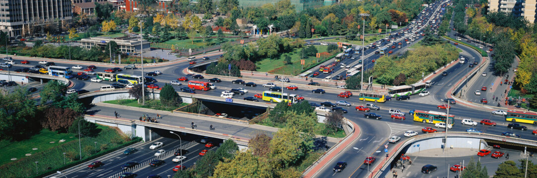 Urban overpasses and busy roads with car and bus traffic adjacent