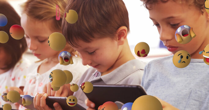 Emoji icons with school children using tablets in the background 4k