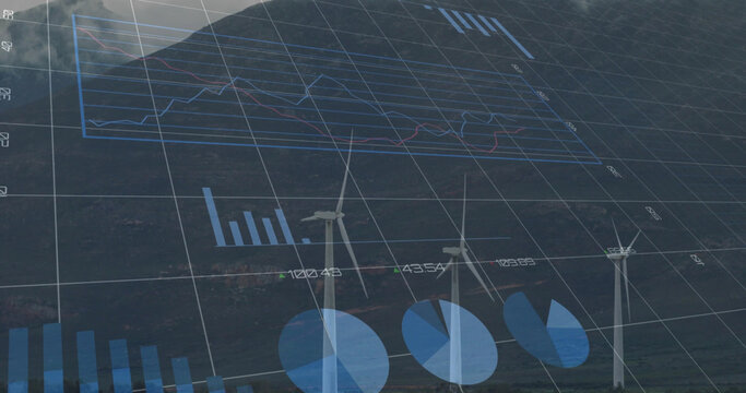 Image of multiple graphs with changing numbers over windmill against mountain and cloudy sky
