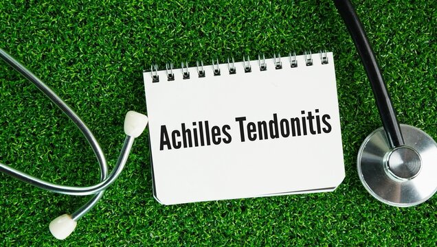 Stethoscope and paper with the word Achilles tendonitis -also called Achilles tendinopathy is irritation, inflammation, or micro-tearing of the Achilles tendon&mdash;the thickest and strongest tendon 