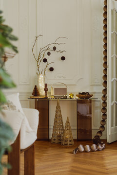 Elegant and Cozy Christmas Interior with Warm Lighting, Wicker Tree Sculptures, and Festive Holiday Decor in a Classic Living Room Setting