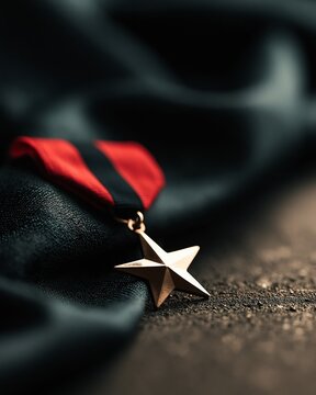 Bronze star military medal with red and black ribbon on dark fabric, symbol of honor and veteran recognition