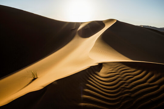 Sand dunes with sunlight and shadows near Merzouga