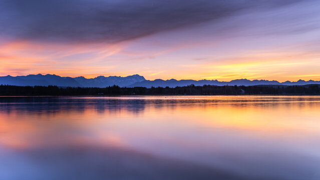 Lake starnberg at sunset with mountain reflections in Bavaria Germany