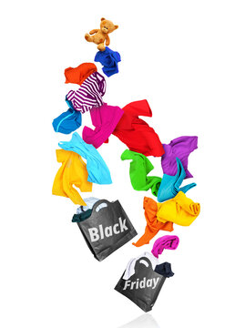 Flying colorful clothes falling out of two black paper shopping bags, creative Black Friday commercial sales levitation concept isolated on white background