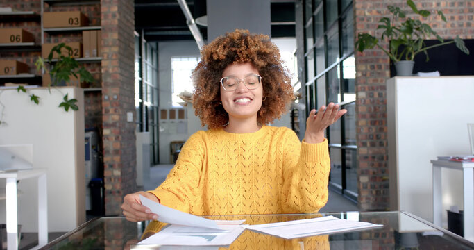African american casual businesswoman walking with tablet in office
